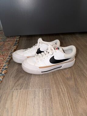 Nike White Low-Top Sneakers with Black Swoosh and Tan Trim